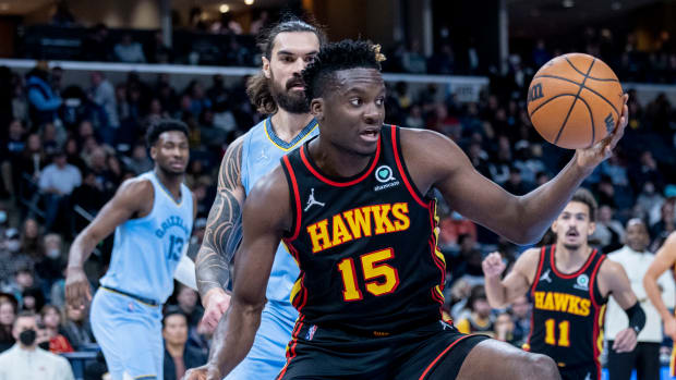 Hawks center Clint Capela rebounds the ball in front of Grizzlies center Steven Adams.